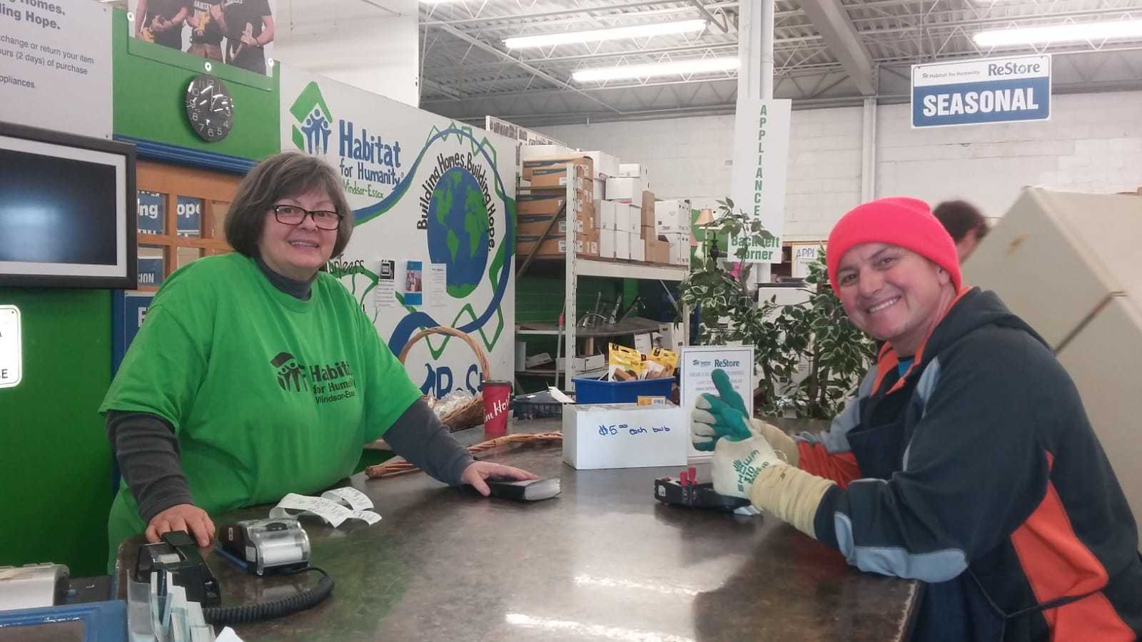 Habitat Restore volunteer Lynn at counter with another volunteer